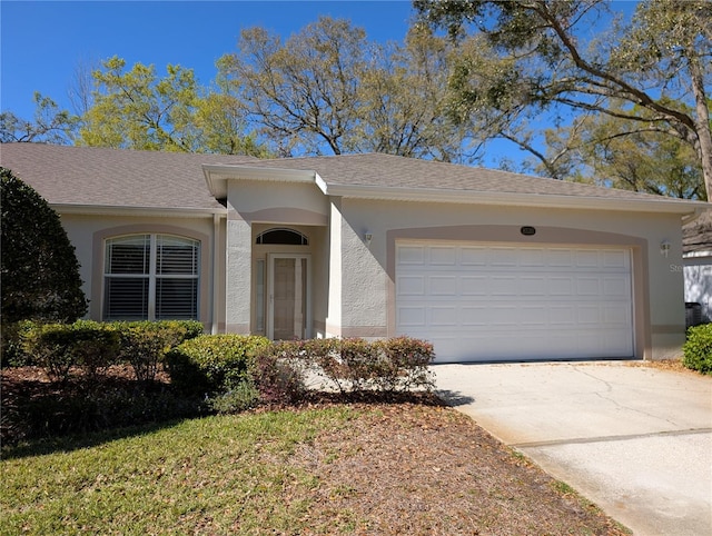 single story home featuring concrete driveway, a shingled roof, an attached garage, and stucco siding