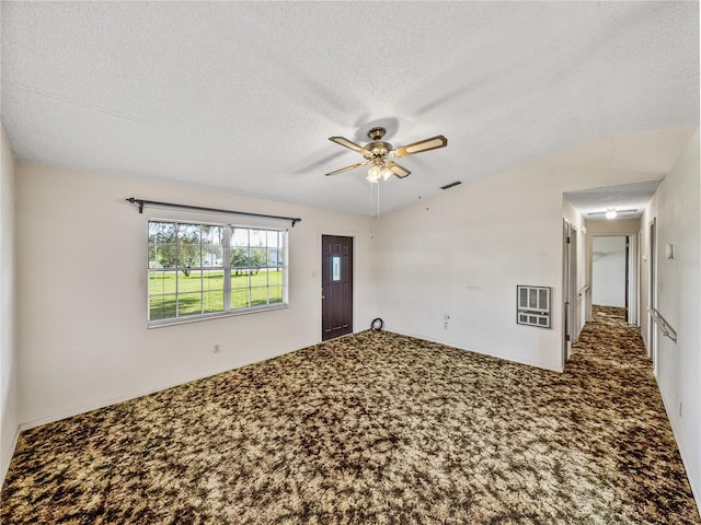 empty room with a ceiling fan, a textured ceiling, visible vents, and carpet flooring