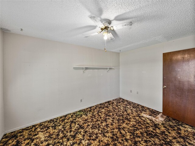 carpeted spare room featuring ceiling fan, a textured ceiling, and baseboards