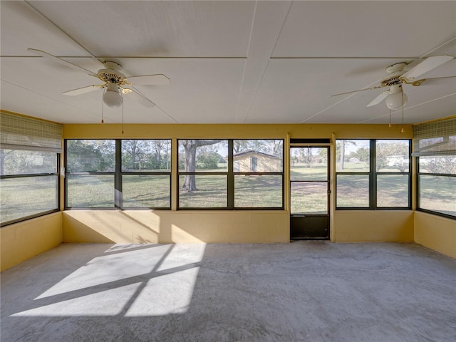 unfurnished sunroom featuring ceiling fan