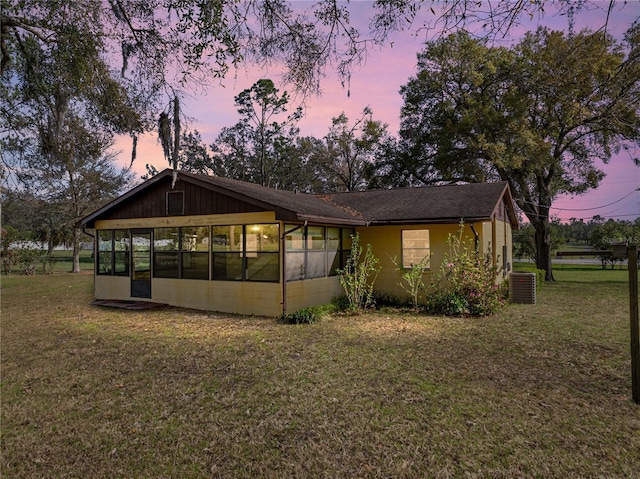 exterior space featuring a sunroom and a yard