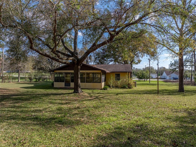 exterior space with a sunroom and a front lawn