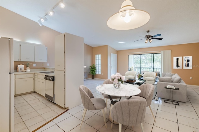 dining area featuring ceiling fan, track lighting, and light tile patterned floors