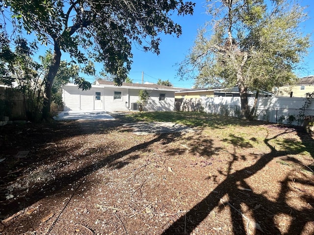 rear view of house featuring cooling unit and fence