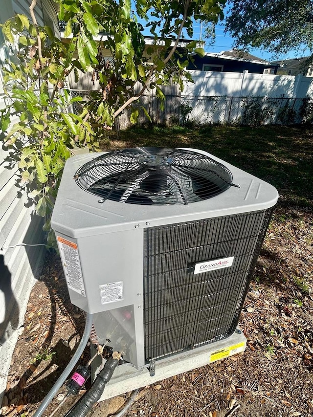 details featuring fence and central AC unit