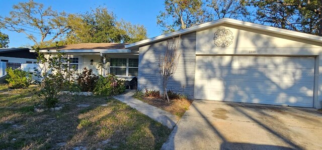 single story home featuring a garage and driveway