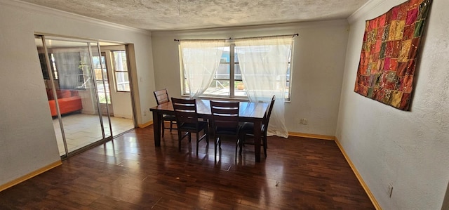 dining space featuring a textured ceiling, hardwood / wood-style floors, ornamental molding, and baseboards