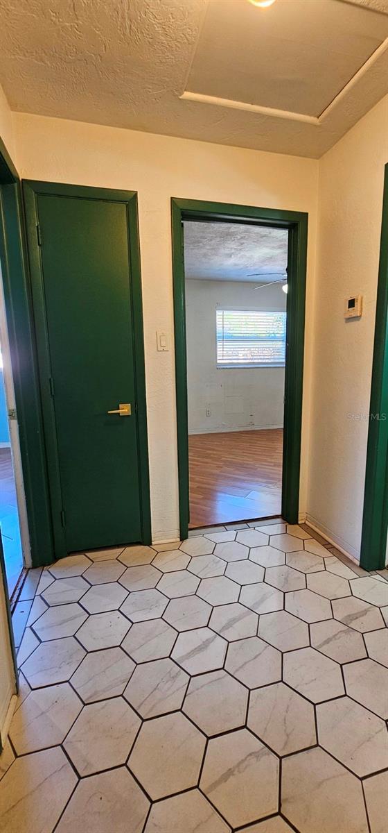 interior space with light floors and a textured ceiling