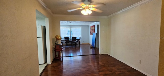 corridor with baseboards, a textured wall, wood finished floors, crown molding, and a textured ceiling