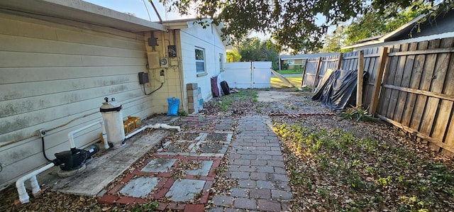 view of yard featuring a fenced backyard and a gate