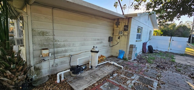 view of property exterior with fence and cooling unit