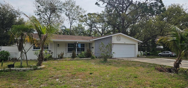 ranch-style house featuring a garage, driveway, and a front lawn