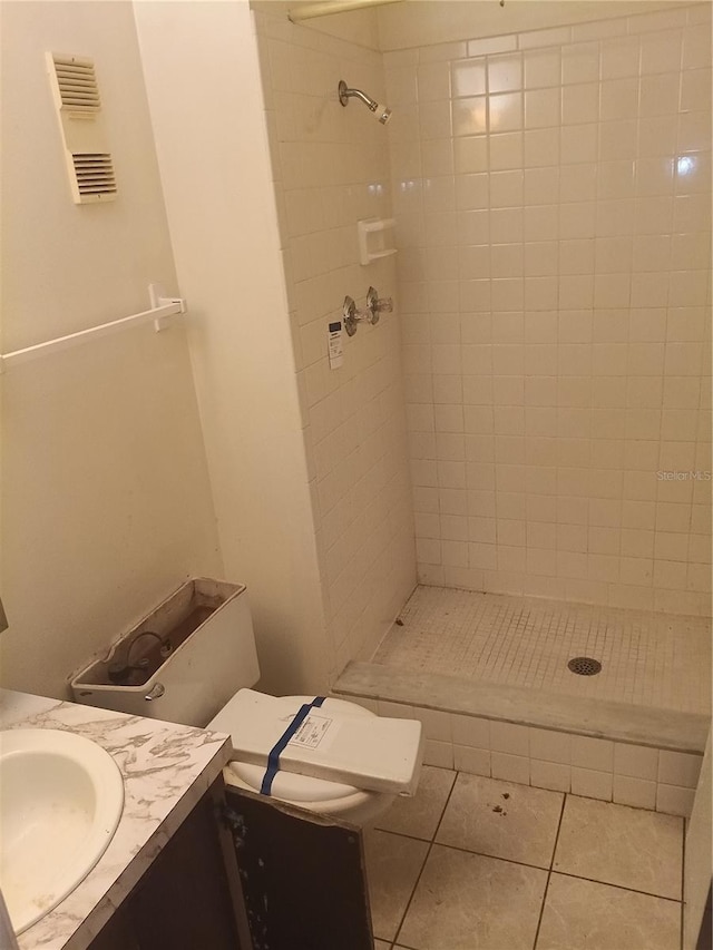 bathroom featuring visible vents, toilet, a stall shower, vanity, and tile patterned floors