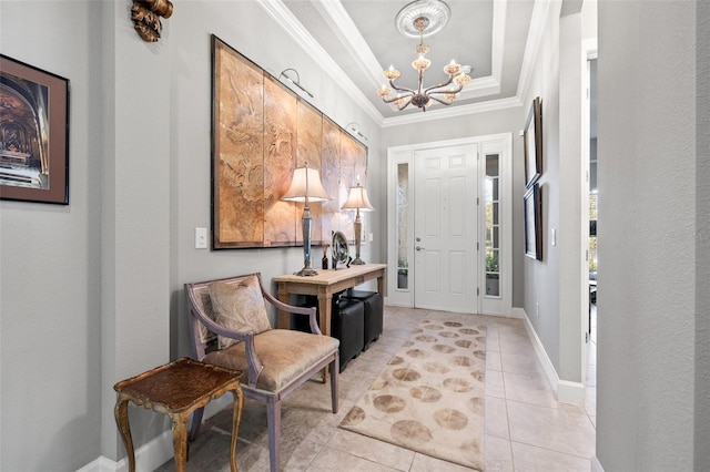 entryway with baseboards, a tray ceiling, light tile patterned flooring, crown molding, and a chandelier