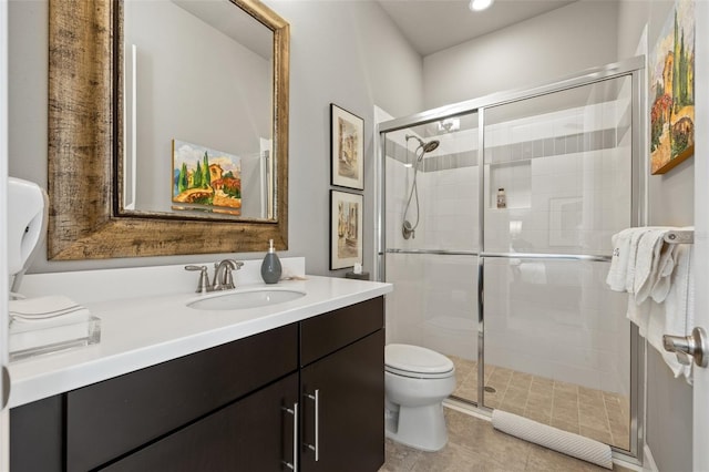 bathroom with tile patterned floors, toilet, a stall shower, and vanity