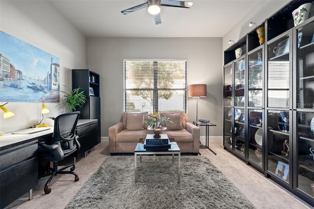 office area featuring baseboards and a ceiling fan