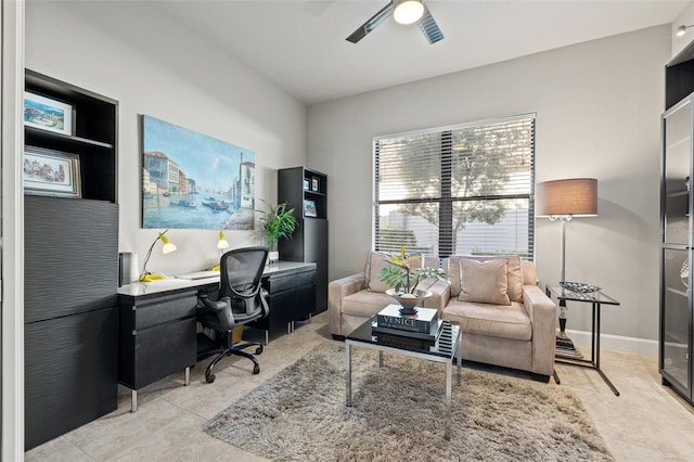 office space with baseboards and ceiling fan