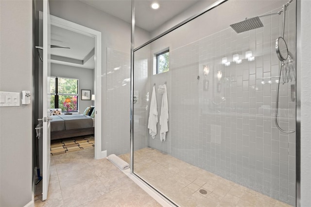 bathroom with plenty of natural light, connected bathroom, and tiled shower