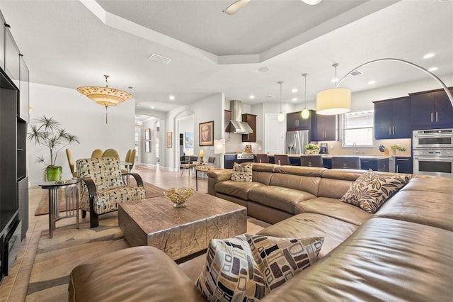 9708 Highland Park Pl, Palmetto, FL 34221 - living area featuring recessed lighting, arched walkways, and a tray ceiling