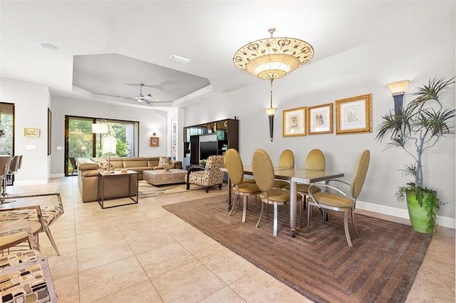 9708 Highland Park Pl, Palmetto, FL 34221 - dining space with a tray ceiling and light tile patterned floors
