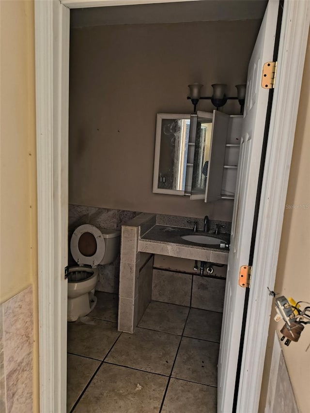 bathroom featuring vanity, tile patterned flooring, and toilet