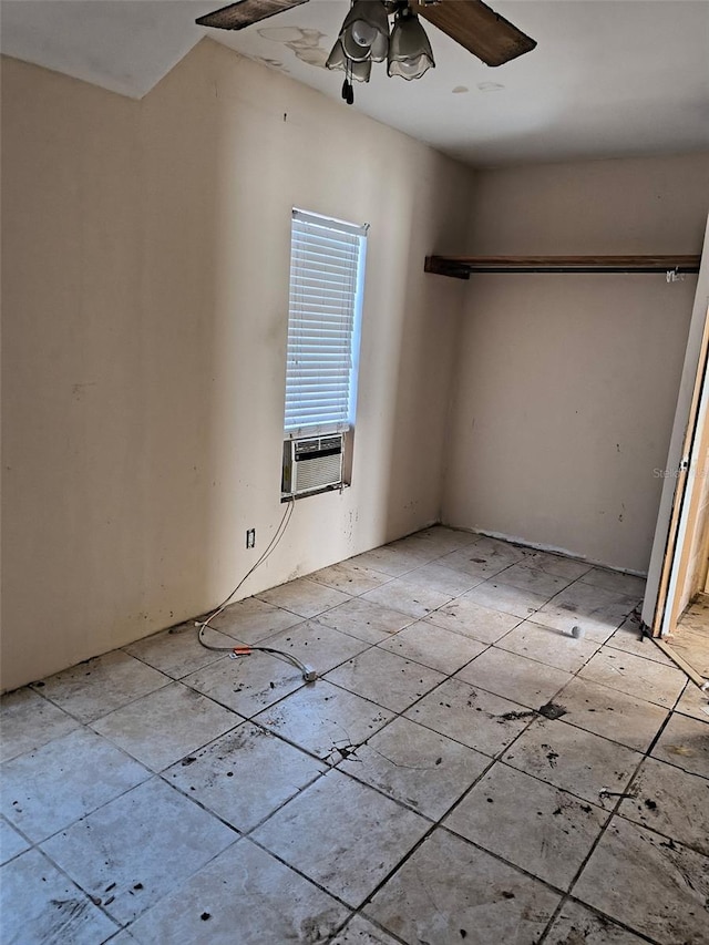 unfurnished bedroom with a ceiling fan and cooling unit