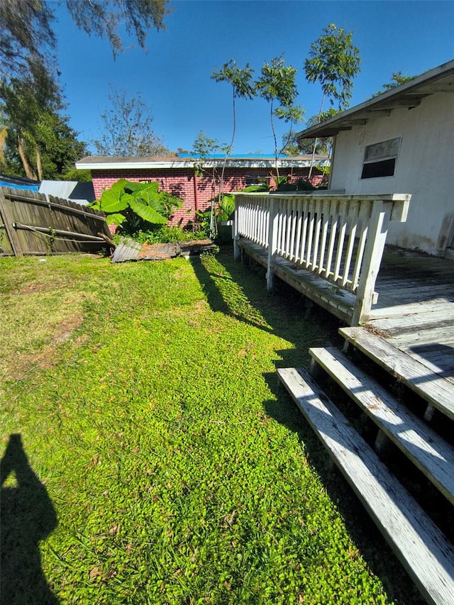 view of yard featuring fence and a wooden deck