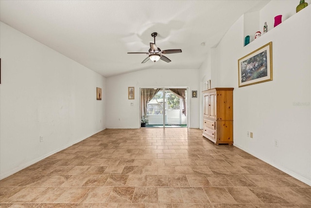 spare room with lofted ceiling, baseboards, and a ceiling fan