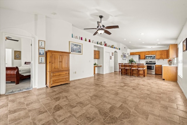 kitchen with ceiling fan, appliances with stainless steel finishes, and open floor plan