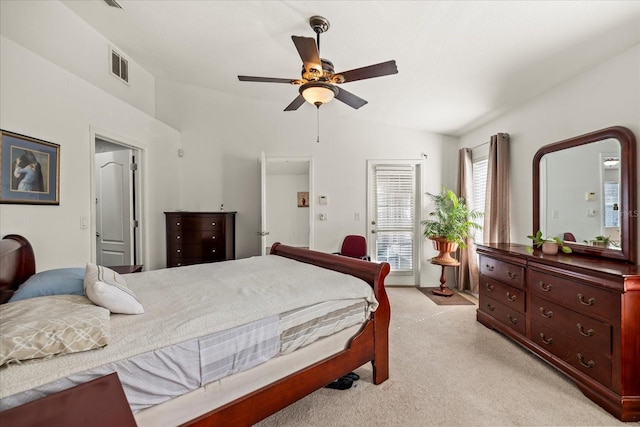 bedroom featuring light carpet, vaulted ceiling, visible vents, and a ceiling fan