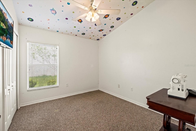 unfurnished bedroom with carpet floors, ceiling fan, baseboards, and vaulted ceiling