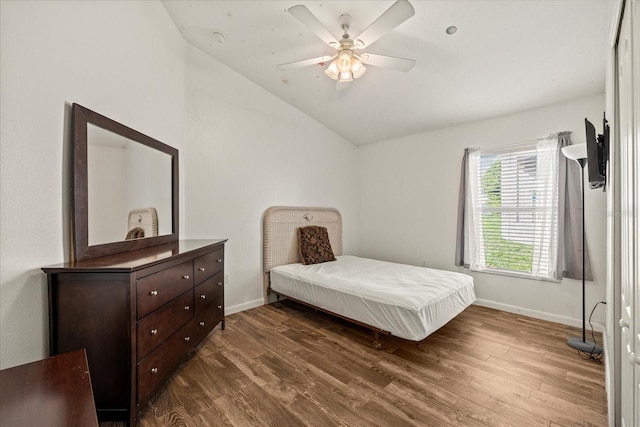 bedroom featuring ceiling fan, baseboards, vaulted ceiling, and dark wood-style flooring