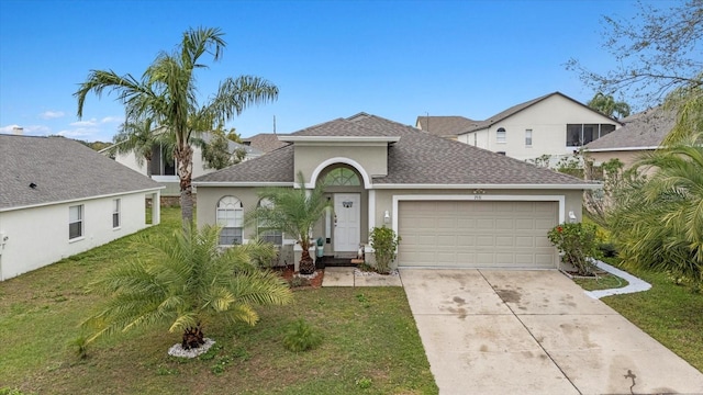 view of front of house with driveway, a shingled roof, stucco siding, an attached garage, and a front yard