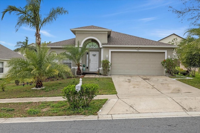 view of front of house featuring an attached garage, driveway, a shingled roof, and stucco siding