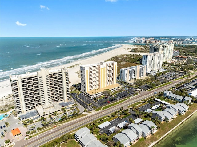 bird's eye view featuring a water view, a view of city, and a beach view