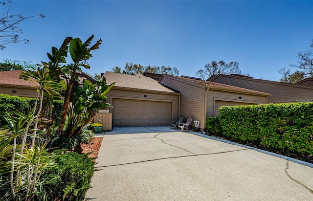 view of front facade featuring concrete driveway and an attached garage