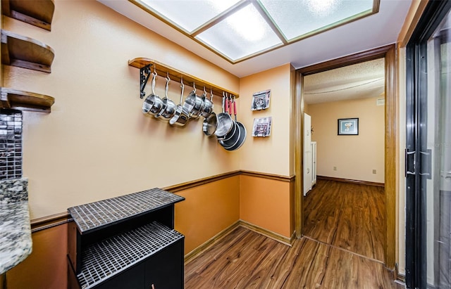 mudroom featuring wood finished floors and baseboards