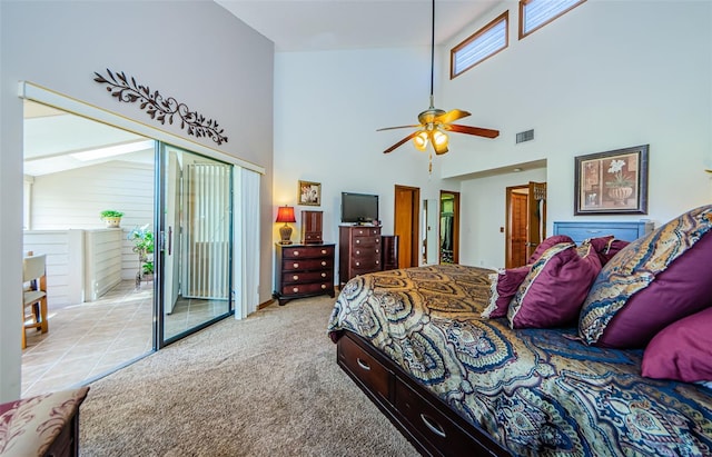 bedroom with access to exterior, light colored carpet, visible vents, a high ceiling, and a ceiling fan