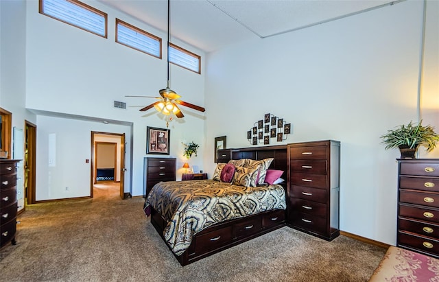 carpeted bedroom with a towering ceiling, visible vents, and baseboards