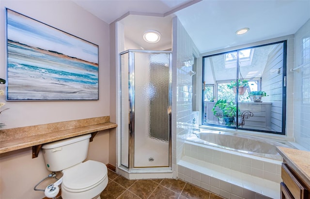 bathroom featuring toilet, vanity, a shower stall, a bath, and tile patterned floors