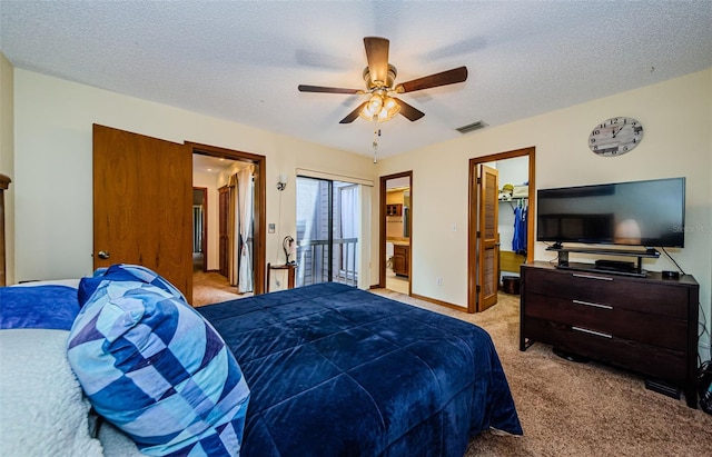 bedroom with a textured ceiling, connected bathroom, light colored carpet, visible vents, and baseboards