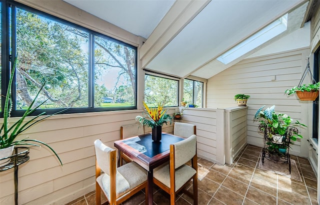 sunroom with vaulted ceiling with skylight