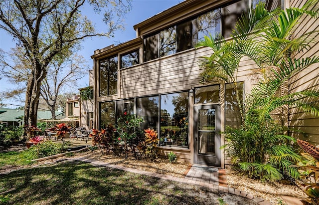 back of house featuring a sunroom and a patio area