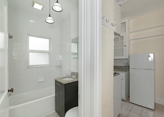 bathroom featuring toilet, tile patterned flooring, shower / tub combination, and vanity