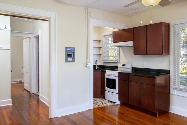 kitchen with a healthy amount of sunlight, under cabinet range hood, white electric stove, and dark wood-type flooring