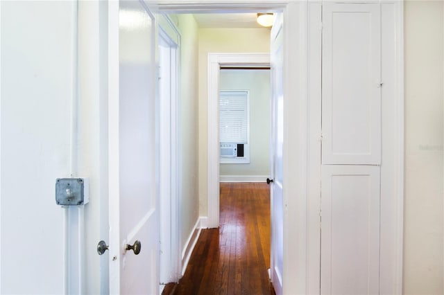 hallway featuring baseboards and dark wood finished floors