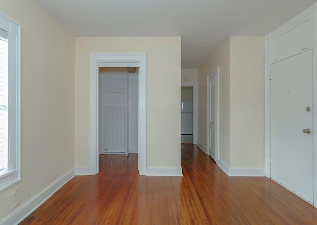 unfurnished room featuring wood finished floors and baseboards
