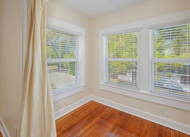 interior space with wood finished floors and baseboards