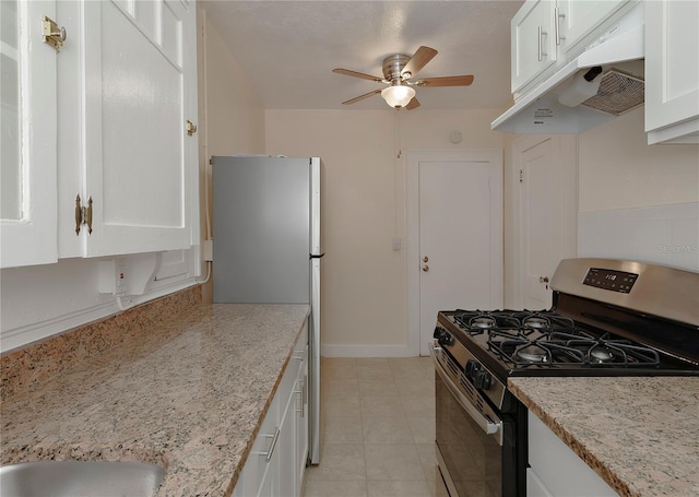 kitchen with white cabinets, under cabinet range hood, stainless steel appliances, and light stone countertops