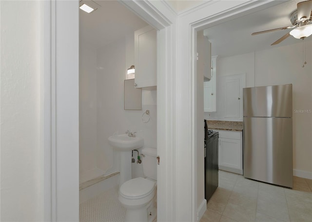 half bath featuring toilet, tile patterned flooring, and ceiling fan